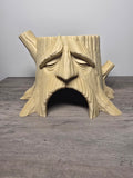 Deku tree-stump aquatic planter with a sculpted face, branch details, and an arched front opening