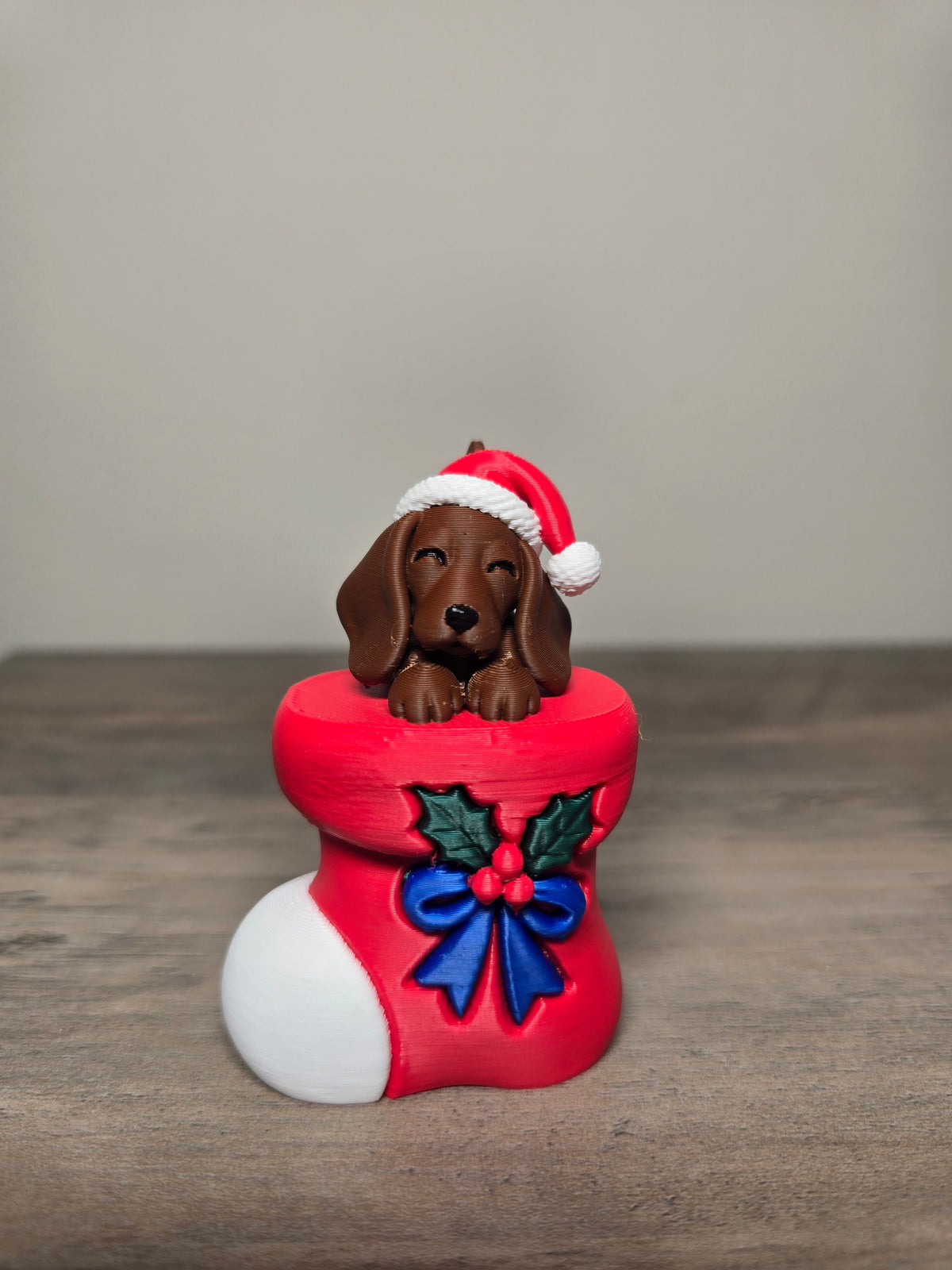 Digitally painted dachshund Christmas ornament wearing a Santa hat in a red stocking