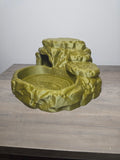 Rock-style reptile bowl with a broad basin, textured cave hideaway, and raised ledges